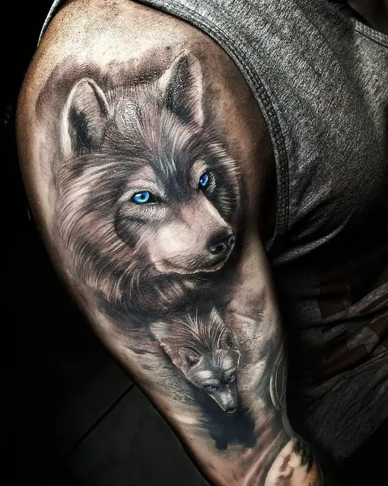 Tatuagem de Lobo com olhos na cor azul no Braço e ombro